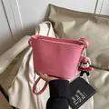 Pink lychee grain leather bucket bag with fashion lettering and cute cartoon pendant - With Pendant Style / Pink