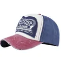 Detail of vintage baseball cap with racing shield patch and distressed torn edge - Wine Red + Navy
