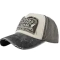 Close-up of distressed ripped details and MOTORS RACING TEAM patch on a vintage cap - Black and Coffee