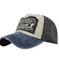 Close-up of distressed vintage Motors Racing Team patch on a washed canvas baseball cap - Navy Blue & Black