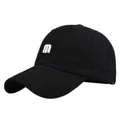 Close-up of white letter m 3D embroidery on a black cotton baseball cap with curved brim - Adjustable / Black
