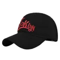 Macro detail of red 3D Brooklyn embroidery on black twill cotton baseball cap fabric - Adjustable / Black