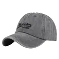 Detailed close-up of charcoal grey washed cotton baseball cap with Rudolfs embroidery - Adjustable / Gray