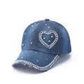 Detail of blue denim baseball cap featuring pearl heart pattern and silver metal rivets - Blue Pearl Heart (Duplicate)