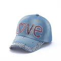 Detail of the LOVE rhinestone and silver stud embellishments on blue denim baseball cap - Light Blue LOVE