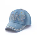 Detailed view of light blue denim baseball cap featuring rhinestones and TAKE lettering - Light Blue TAKE