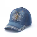 Close-up of rhinestone butterfly on denim baseball cap with crystal studded brim - Blue Colorful Butterfly