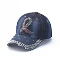 Detailed macro view of dark blue denim baseball cap with pink rhinestones and metal studs - Dark Blue Ribbon Symbol
