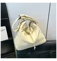 Detail of a creamy white puffy tote bag featuring drawstring closure and soft nylon fabric - One Size / Beige