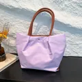Waterproof nylon tote bag with leather handles in lavender purple and brown accents - Purple