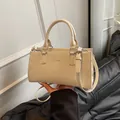 Schicke cremeweiße Handtasche mit Silberlogo, Doppelgriffen und verstellbarem Gurt - Ohne Anhänger / Gebrochenes Weiß