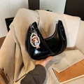Glossy black hobo shoulder bag with a decorative pearl charm and patent leather finish - With Pendant / Black