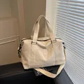 Minimalist beige travel bag in canvas with logo detail and adjustable shoulder strap - Off White