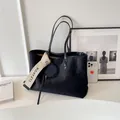 Large black quilted tote bag with matte finish and stylish lettered strap pendant - Black