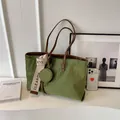 Green matte tote bag with rhombus texture and detachable coin purse on white desk - Green