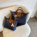 Contrast color large nylon tote bag in navy blue with brown leather handles and charm - Small With Charm / Blue