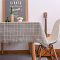 Close-up of gray checkered cotton linen tablecloth draped over a wooden dining table - 60*60cm / Gray Plaid