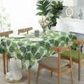 Nordic cotton linen tablecloth with green monstera leaf print on rectangular table - Monstera Leaves