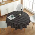 Detail of round cotton linen tablecloth featuring a classic black and white checkered pattern - Black Check