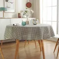 Detail of round cotton linen tablecloth featuring a gray-green grid pattern in a bright room - Gray Plaid