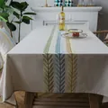Nordic linen tablecloth with geometric leaf embroidery on a wooden dining table - 90x90cm / Multicolor Embroidered Leaves Style