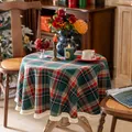 Detail of red and green plaid round tablecloth with cream fringe in a festive setting - 150cm / Christmas Green Plaid with Tassels