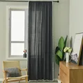 Detail of dark grey sheer curtain with white pom-pom fringe edge in a cozy room - Extra Long Style