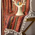 Detail of bohemian cotton linen runner with gold stripes and white tassels on a marble table - Bronzed Red Stripe Hook
