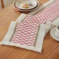 Detail of red geometric diamond embroidery and white tassels on a woven cotton table runner - Red Hemp Woven