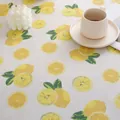 Close-up of lemon print cotton linen tablecloth with cozy home decor setting - Lemon