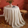 Detailed close-up of ruffles on a round cream cotton tablecloth in a cozy home setting - Round 120cm / Off White Ruffle