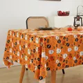 Halloween festive tablecloth detail featuring orange pumpkins and ghosts in a cozy home setting - Vibrant Orange Pumpkin