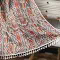 Bohemian geometric woven throw blanket with white fringe on a vintage wooden chair - 150cmx160cm