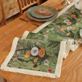 Detail of floral jacquard table runner with fringe on a rustic wooden dining table - 30x240cm / Green Dandelion Style
