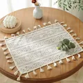 Detailed close-up of ivory lace placemat with floral patterns and fringed edges - Beige Floral With Tassels