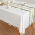Detail of white linen tablecloth with green leaf embroidery and beige fringe tassels - New Wheat Pattern With Tassel
