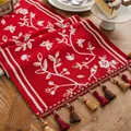 Macro detail of red knitted Christmas table runner with white floral jacquard and tassels - 35x140cm / Red Bird Floral Style