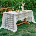 Elegant white lace tablecloth with floral embroidery and scalloped edges on a garden table - 130x240cm / French Tablecloth-Wave Edge