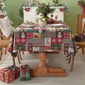 Detail of festive Christmas tablecloth featuring reindeer and Santa patterns on red fabric - Santa Claus Patchwork