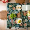 Close-up of thick Christmas tablecloth with jacquard weave and festive bell patterns - Green Background Christmas Floral