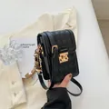 Chic black quilted phone crossbody bag with gold hardware and cartoon charm - Black