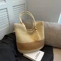 Two-tone woven straw tote bag in beige and brown with decorative tassel and bead - Off White