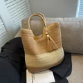 Two-tone woven straw tote bag in khaki and beige with elegant wood bead tassel charm - Khaki