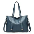 Deep blue leather tote bag with glossy finish and vertical decorative metallic straps - Blue
