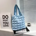 Light blue quilted puffer tote bag with bubble texture and drawstring side detail - Blue