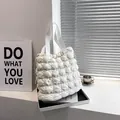 White quilted puffer tote bag with textured cloud pattern and drawstring detail - White