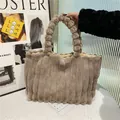 Light brown faux fur tote bag with striped texture and plush ball handle design - Brown