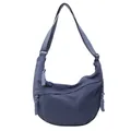 Blue nylon half-moon crossbody bag with woven rope zipper detail and adjustable strap - Blue