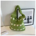 Detail der grünen Strick-Tote-Bag mit cremefarbenen Herzmustern und grobem Zopfmuster - Hellgrün und Aprikose