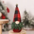 Close-up of Christmas gnome with buffalo plaid hat and silver bell on a wooden stand - Red and Black Plaid Tree Gnome